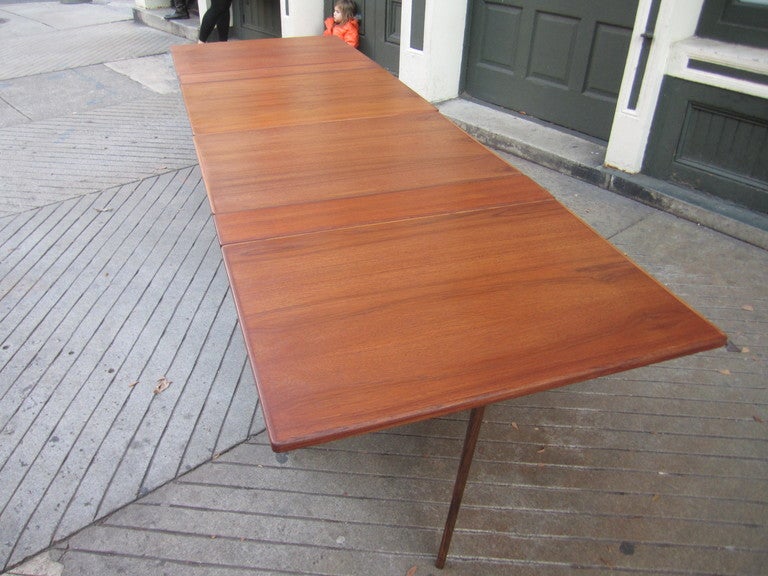 Unique drop leaf table that can seat up to 14/16  consists of two separate tables which can be joined together  via a male female brass connection.  Please look at all the photos to understand the tables complete function.  Table can be used as two